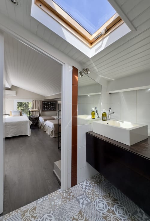 Salle de bains moderne avec douche à la VillaSerenita à Alata, puits de lumière, équipements blancs, carrelage motifs et accès à la chambre