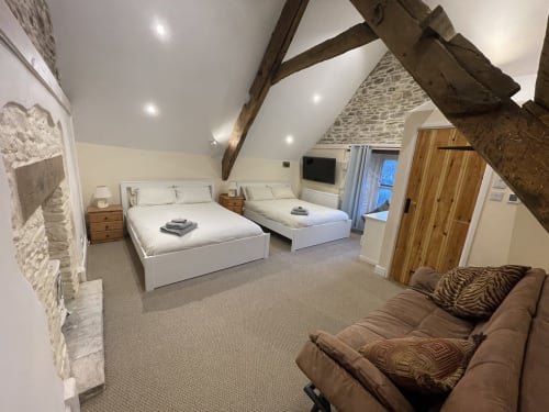 Exposed beams vaulted ceilings feature bed large farmhouse group stay accommodation family friendly