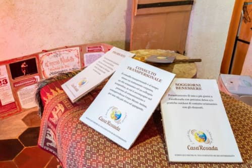 CasaRosada B&B welcome materials displayed on table in Vidracco with brochures and information documents