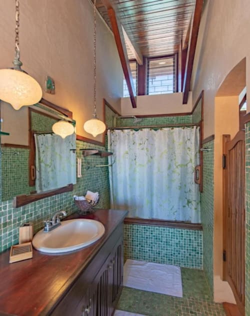 Rana room bathroom at Villa Mango B&B in Nosara with green tile, wooden vanity, and walk-in shower