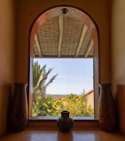 Arched doorway at Villa Mango B&B opens to lush garden view in Nosara, Costa Rica