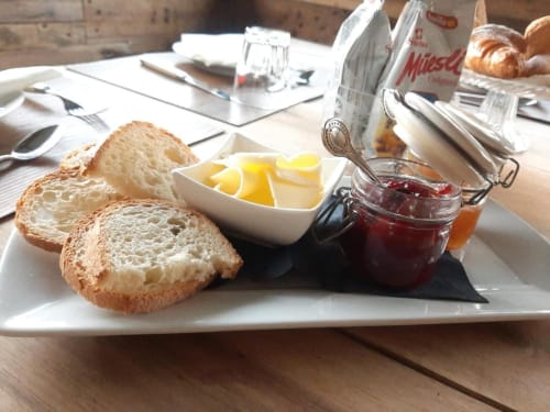 Kontinentales Frühstück im Locanda del Sasso: geröstetes Brot, Butter und Marmelade auf weißem Teller