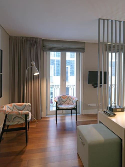 Modern studio apartment at New Oporto Apartments in Porto with wooden floors, city view from balcony, and contemporary