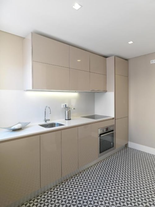 Modern kitchen in Deluxe Apartment at New Oporto Apartments, Porto, with beige cabinetry, white countertops, stainless steel