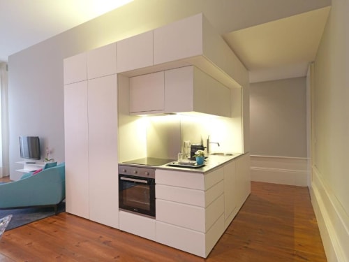 Modern white kitchenette with island counter in Superior Apartment at New Oporto Apartments, Porto