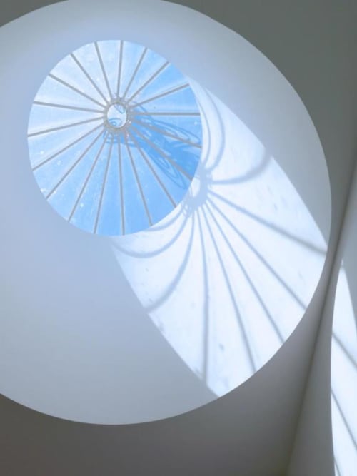 Spiral staircase with skylight view of blue Porto sky in Deluxe Apartment at New Oporto Apartments