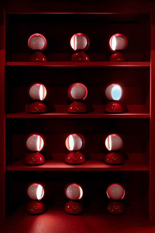 Red illuminated spheres on shelves at YOUnique Boutique Rooms, Milano luxury boutique hotel display