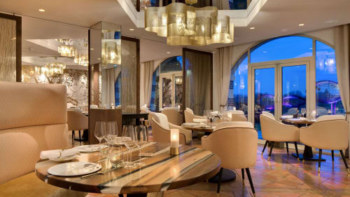Elegant fine dining room at Le Prieuré Du Preux with arched windows overlooking Sépeaux Saint Romain