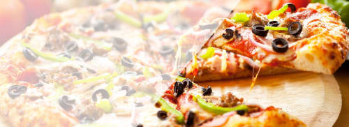 Fresh pizza slices with olives and peppers at Le Prieuré Du Preux B&B in Sépeaux Saint Romain, France