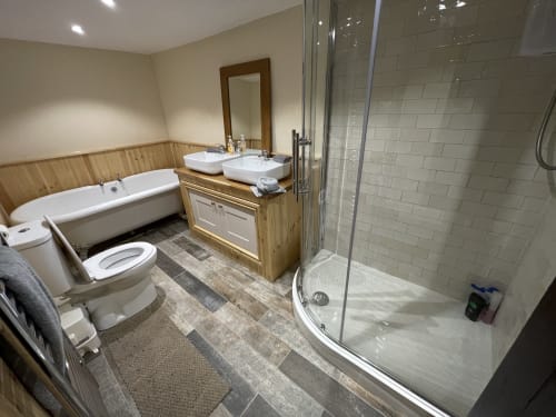 Large family bathroom in historic farmhouse large shower double vanity standalone bath