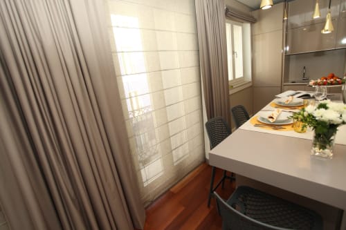 Modern dining area in New Oporto Studio Apartment with white table, city view through large windows, and contemporary kitchen