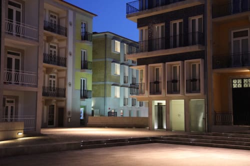 New Oporto Apartments courtyard in Porto at night, featuring modern residential buildings with illuminated facades and