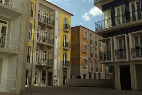 Inner courtyard of New Oporto Apartments in Porto with colorful residential buildings and balconies surrounding a peaceful