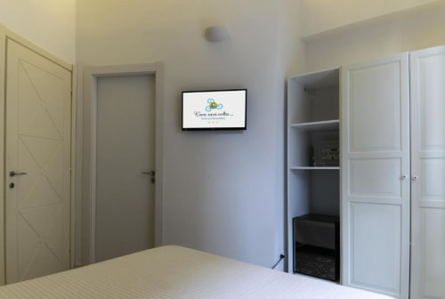 Deluxe Double Room at C'era una Volta B&B in Palermo featuring bed, TV, wardrobe, and garden view
