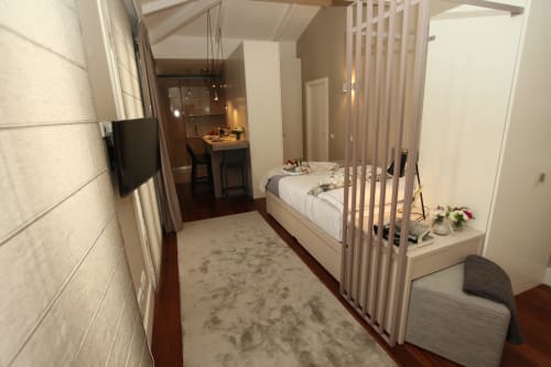 Modern apartment bedroom at New Oporto Apartments Porto with queen bed, TV, kitchenette and dining area
