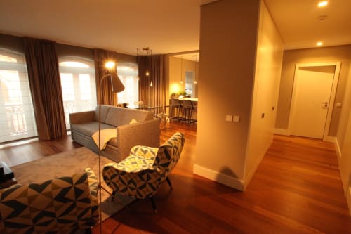 Superior Apartment at New Oporto Apartments in Porto featuring modern living area with wooden floors, sofa, armchair, and