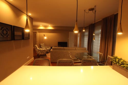 Modern open-plan dining and living area in Superior Apartment at New Oporto Apartments Porto, with pendant lighting and city