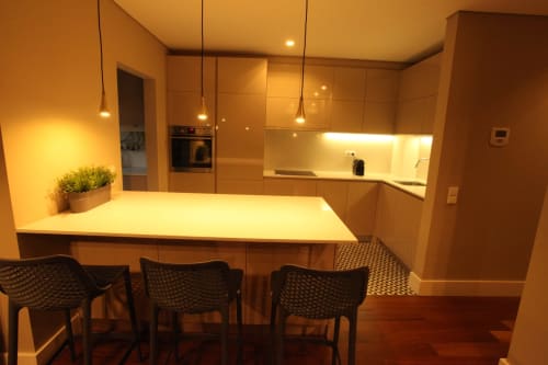 Modern kitchen with island seating, wooden cabinetry, and pendant lighting in Superior Apartment at New Oporto Apartments,