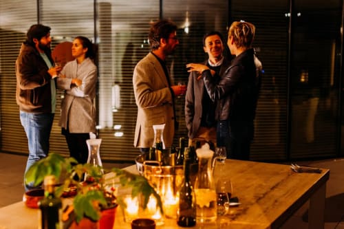 Les hôtes se côtoient aux Maisons de Chamirey, un gîte à Mercurey, dégustant du vin lors d'une soirée conviviale.