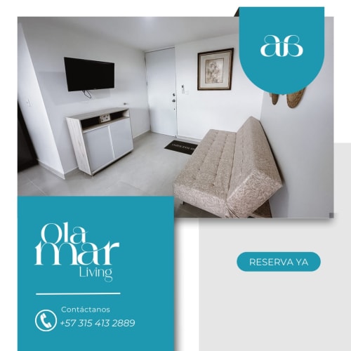 Habitación moderna del hotel Olamar Living en Santiago de Tolú con cama, televisor y decoración minimalista
