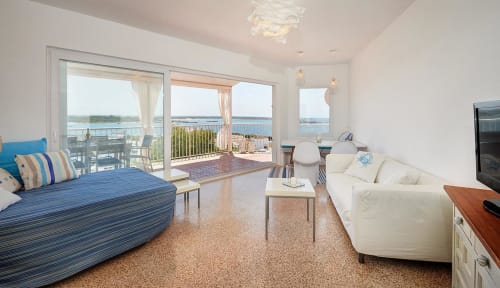 Bright beachfront suite in Colonia de Sant Jordi with sea views, modern furnishings, and direct balcony access.