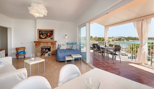 Bright coastal suite with sea views, fireplace, and terrace at Colonia de Sant Jordi hotel