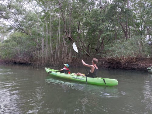 Two kayakers paddling through mangrove waterway in Nosara, Costa Rica near Villa Mango B&B