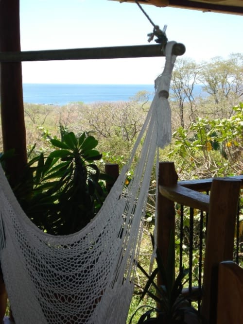 White hammock hanging on coastal terrace at Villa Mango B&B in Nosara, Costa Rica with ocean view