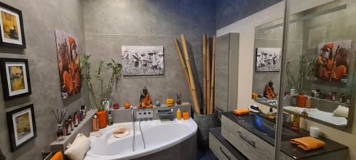Salle de bain d'inspiration spa moderne au Cocon de Chris Marseille avec accents orange, baignoire îlot et décoration bouddhiste