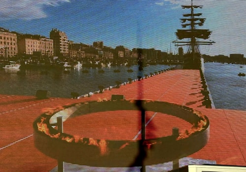 Vue du front de mer de Marseille depuis l'hôtel Le Cocon de Chris, skyline de la ville, terrasse rouge et mât de voilier