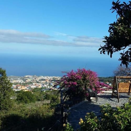 Terraced sea view at Casonas de Marengo in Icod de los Vinos with blooming bougainvillea and coastal landscape