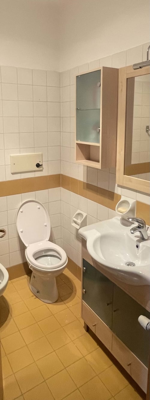 Private bathroom in Varenna by Foot Green House apartment with white sink, toilet, and tiled floor