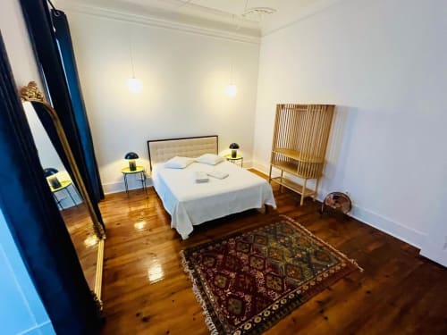 Modern bedroom at Royal Prince Garden Apartments Lisboa with white bed, pendant lights, wooden floors, and contemporary