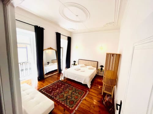 Quarto elegante no Royal Prince Garden Apartments em Lisboa com cama de dossel, assoalho de madeira e decoração tradicional