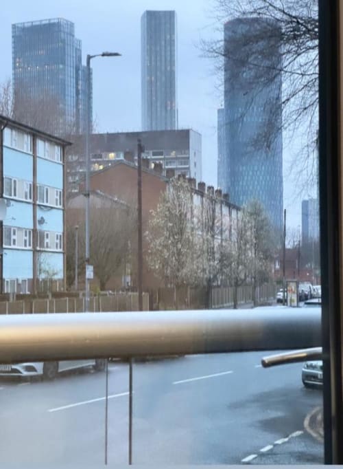 Manchester city skyline view from Cila Property apartment balcony with modern high-rise buildings
