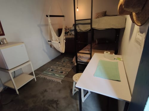 Departamento LLUNA en Oaxaca con camas altas, escritorio de trabajo, hamaca y mobiliario moderno sobre pisos de concreto