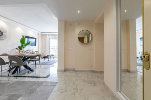 Modern hallway entrance at Marina Banús apartment in Marbella with marble flooring and contemporary décor