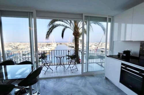 Modern Puerto Banús apartment with sea views, marble flooring, equipped kitchen, and furnished balcony overlooking the