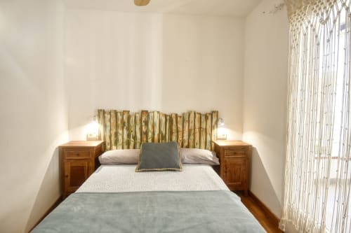 Cozy bedroom at Finques Garcia Enrich apartment in Palafrugell with queen bed, wooden nightstands, and natural light from