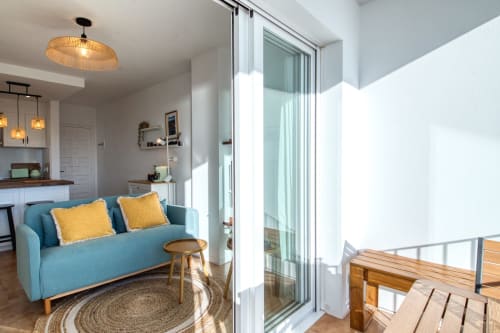 Modern apartment with turquoise sofa and yellow cushions, sea view balcony access in Palafrugell