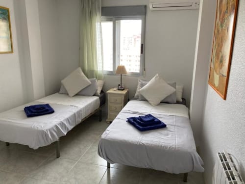 Twin bedroom with sea view balcony at Tads Holiday Lets Benidorm apartment