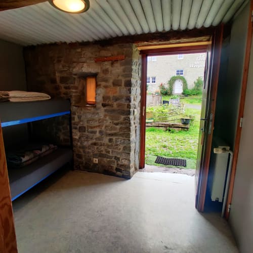 Ground floor apartment at La Ferme De Werpin with fireplace, sitting area, and direct garden access in Hotton, Belgium