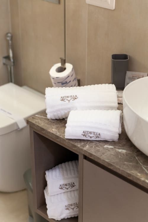Altavilla Boutique towels arranged on bathroom counter with toiletries in Marsala guesthouse