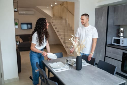 Young couple in modern kitchen-dining area of Altavilla Boutique Holidays House family apartment in Marsala, Italy