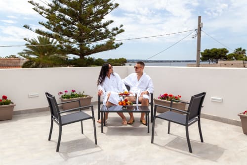 Couple relaxing on rooftop terrace at Altavilla Boutique Holidays House in Marsala with sea views