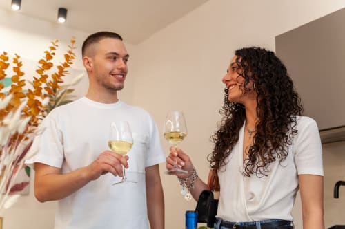 Couple toasting with white wine at Altavilla Boutique Holidays House in Marsala, Italy