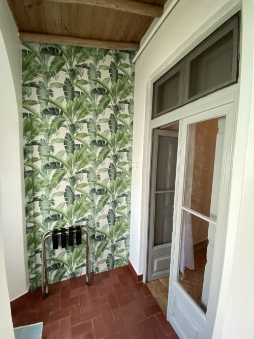 Corredor do banheiro com vista para o jardim, papel de parede de folhagens tropicais e piso de azulejo terracota na pousada Patio Da Villa em Coruche,