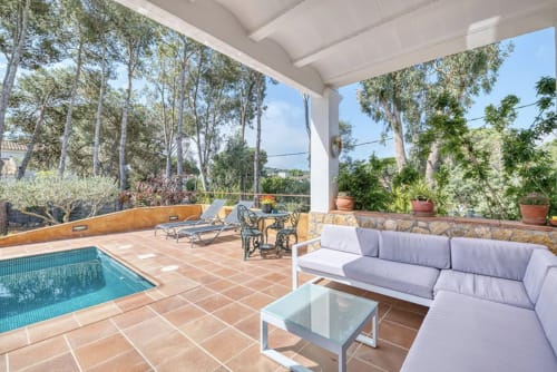 Coastal cottage patio with private pool, lounge seating, and sea views in Palafrugell
