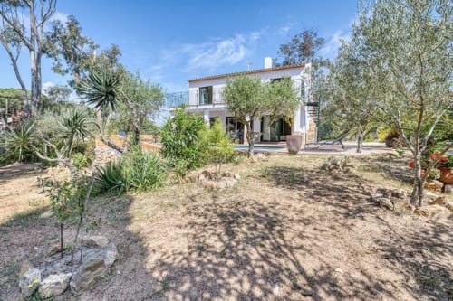 Whitewashed cottage in Palafrugell surrounded by olive trees and Mediterranean garden, 600m from beach