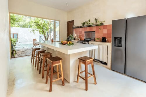 Cocina Casa Tuch en Mérida con barra central, salpicadero de barro cocido y vistas al patio
